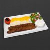 Beef koobideh plate with rice, tomato, and salad.